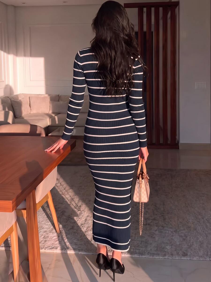 Full front view of navy and ivory striped rib-knit polo sweater dress styled with heels indoors