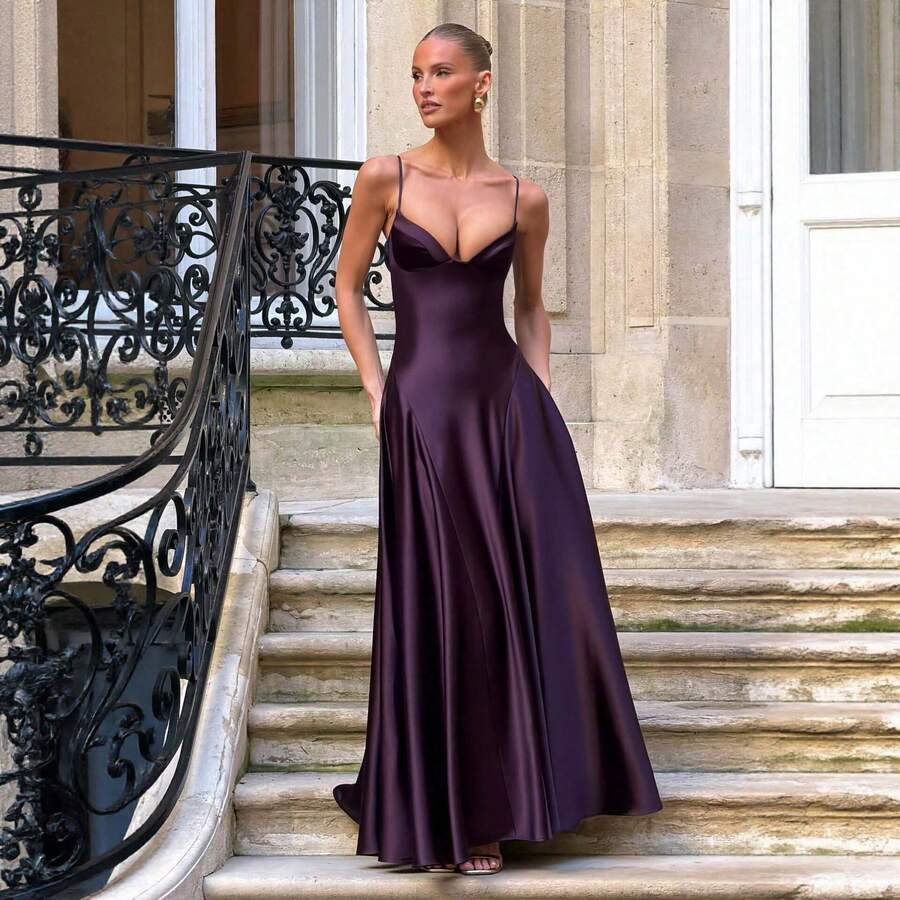 Full-length deep purple satin gown styled on stone steps outdoors
