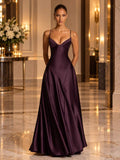 Front view of the plum evening gown in a warmly lit formal interior