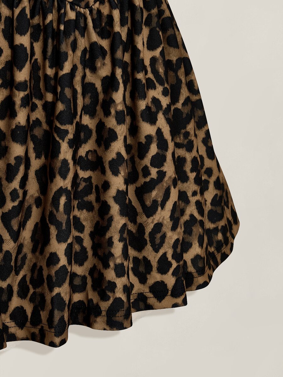 Close-up of gathered flared skirt in brown and black leopard print