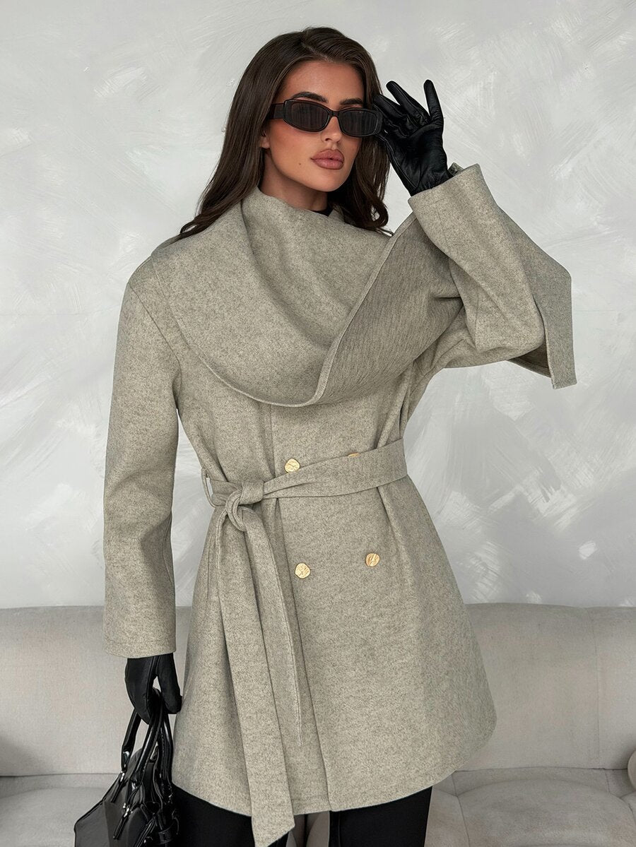 Close front view of grey wrap-collar overcoat with gold-tone double buttons, tied belt and soft textured fabric