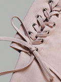 Close-up of dusty pink dress waist panel lacing threaded through metal eyelets