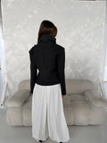 Rear view of short dark grey jacket showing high collar, long sleeves and clean back seam