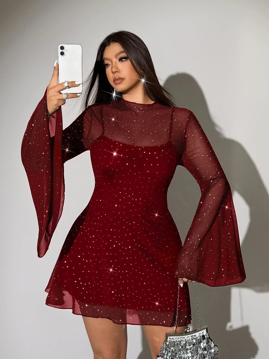 Close front view of red sheer dress bodice showing stand collar, rhinestone-like sparkle and long flared sleeves