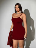 Front view of solid red fitted camisole included beneath the sheer embellished cover-up dress