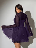Front selfie view of purple sparkling sheer mini dress with camisole and flared sleeves