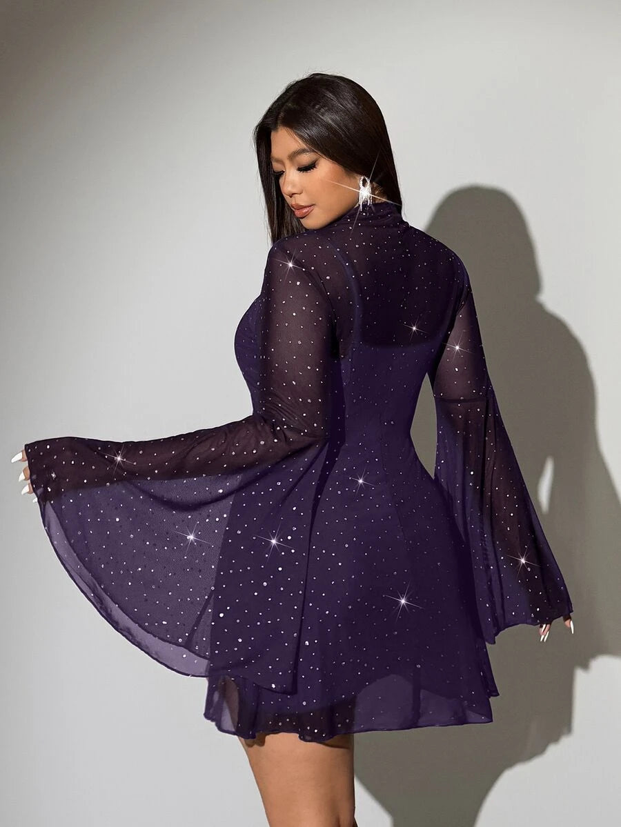 Front selfie view of purple sparkling sheer mini dress with camisole and flared sleeves