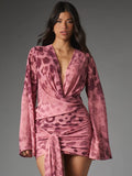 Front three-quarter view of rose animal-print mini dress with wrap bodice, long sleeves, gathered skirt and long sash