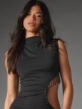 Close view of black high-neck sleeveless dress showing ruched knit front and bead-trimmed diagonal waist cut-out