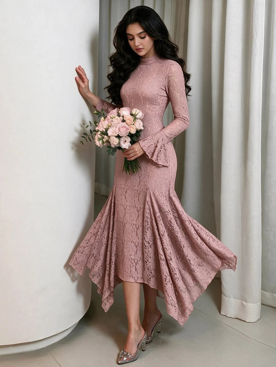 Model holding a bouquet in the floral lace dress, showing its fitted bodice, bell sleeves and flowing hem.