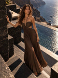 Brown pleated open-back halter maxi dress with tie closure, front three-quarter view