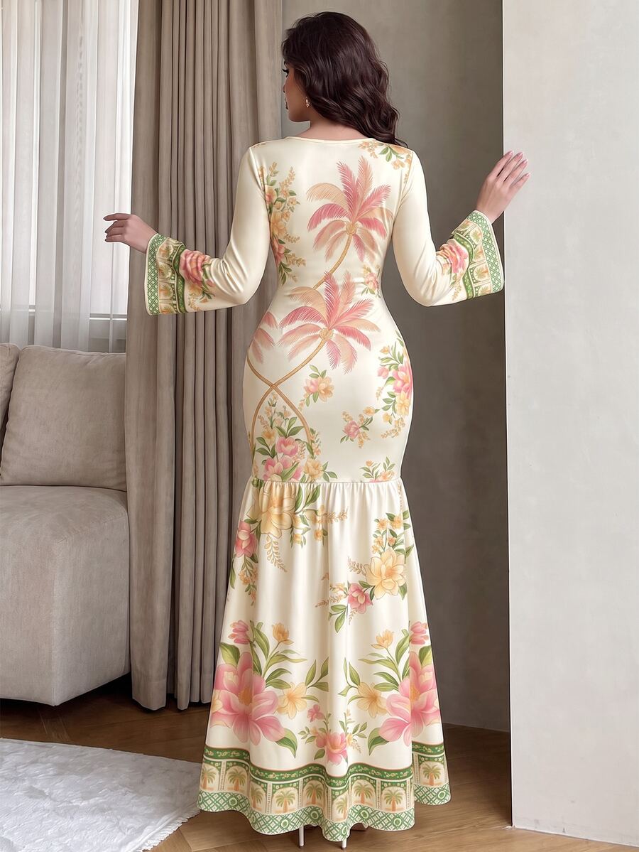 Front view of ivory palm floral mermaid maxi dress with flared sleeves and green patterned hem