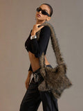 Side styling view of oversized brown furry star shoulder bag worn over the shoulder