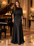 Closer front view of black gown highlighting boat neck, open batwing sleeves and natural waist