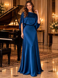 Front view of royal blue floor-length gown with flowing skirt in formal interior