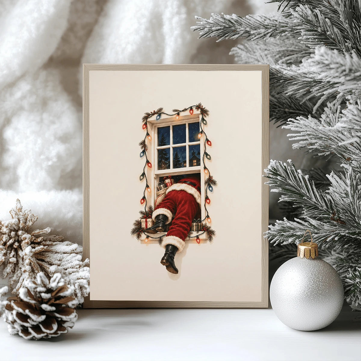 Framed Santa climbing through a lit window print among snowy evergreen branches and ornament