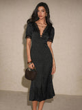 Front three-quarter black polka-dot midi dress with lace trim and handbag