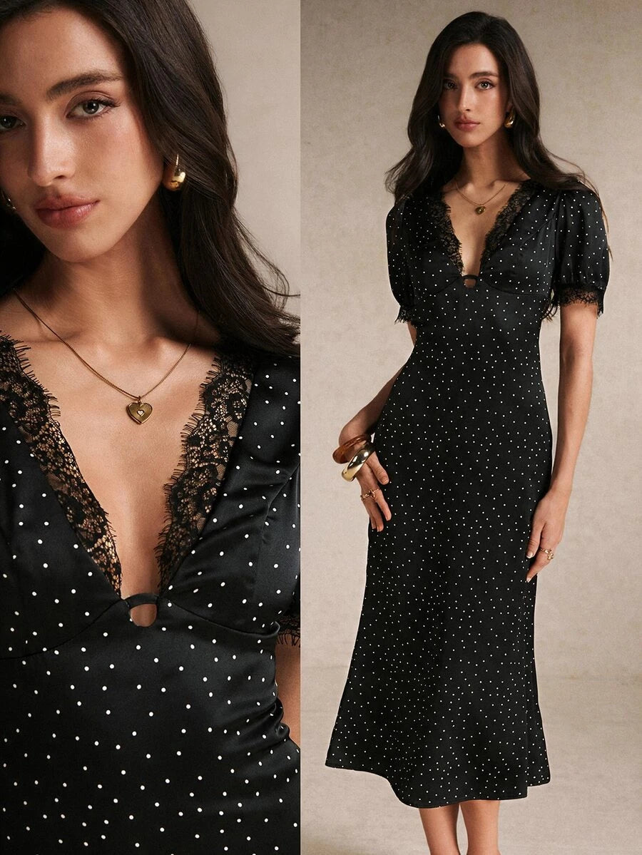 Black polka-dot midi dress close-up with lace V-neck and puff sleeves