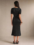 Back view black polka-dot midi dress with waist tie and lace cuffs