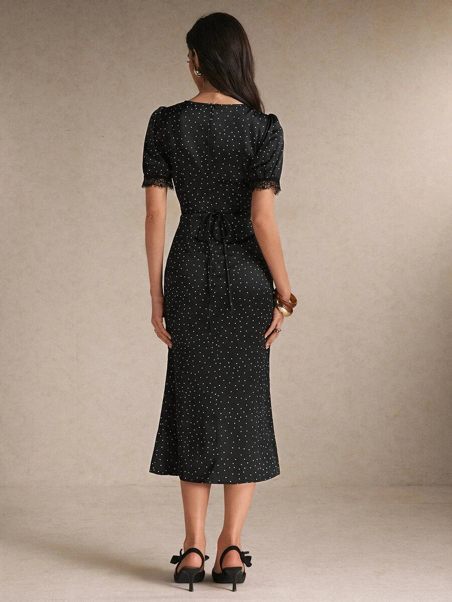 Back view black polka-dot midi dress with waist tie and lace cuffs