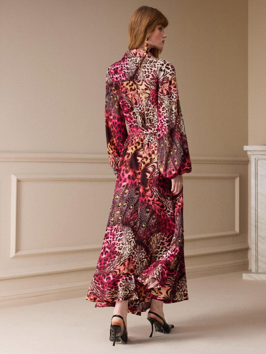 Rear view of the long animal-print shirt dress showing its loose silhouette, waist shaping and flounced hem.