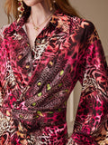 Close view of the animal-print shirt dress collar, button front, wrap waist and patterned flounce sleeve.