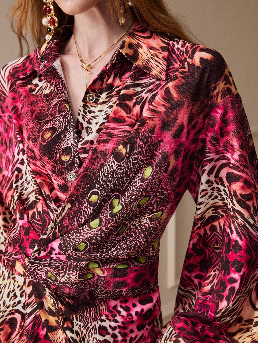 Close view of the animal-print shirt dress collar, button front, wrap waist and patterned flounce sleeve.