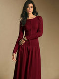 Close front view of the burgundy maxi dress showing textured knit surface, button front, and long sleeves