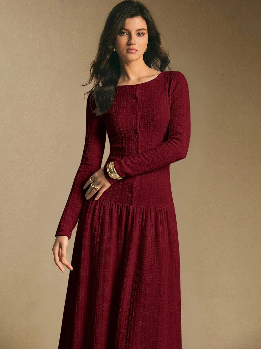 Close front view of the burgundy maxi dress showing textured knit surface, button front, and long sleeves