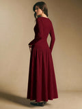 Back view of the burgundy textured maxi dress showing fitted bodice and full flowing skirt