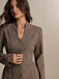 Close-up of houndstooth mini dress neckline and covered button detail in woven fabric