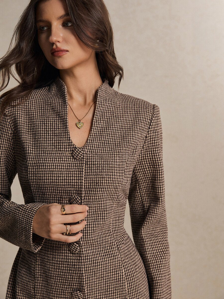 Close-up of houndstooth mini dress neckline and covered button detail in woven fabric