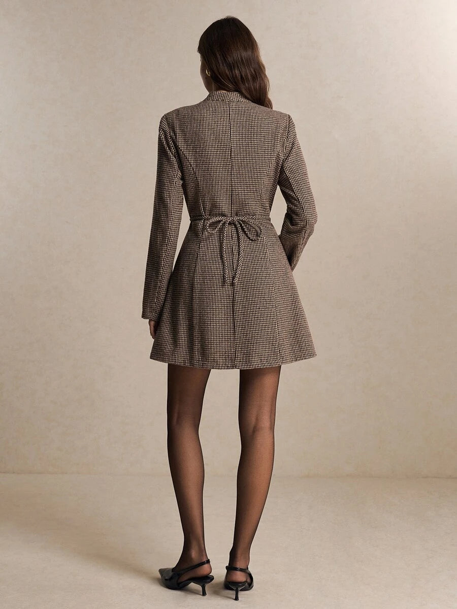 Back view of khaki houndstooth mini dress showing waist tie and flared skirt for fall styling