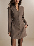 Three-quarter view of khaki houndstooth shirt dress with fitted waist and flared mini hem