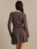 Back view of coffee-brown long-sleeve knit mini dress showing gathered waist and flared skirt