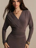Close-up of coffee-brown wrap dress V-neck and ruched high waist in stretch knit