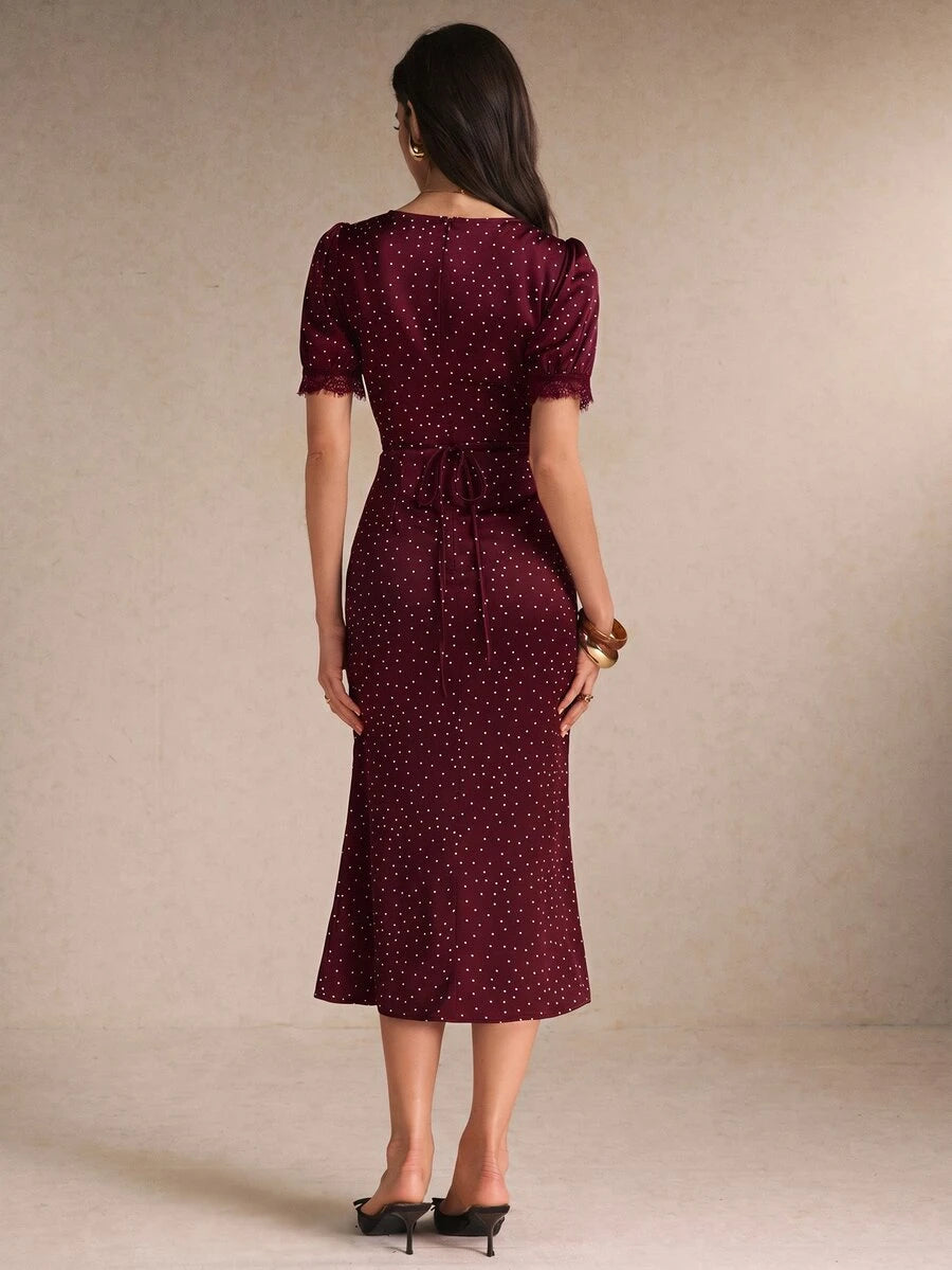 Back view burgundy polka-dot midi dress with waist tie and lace cuffs