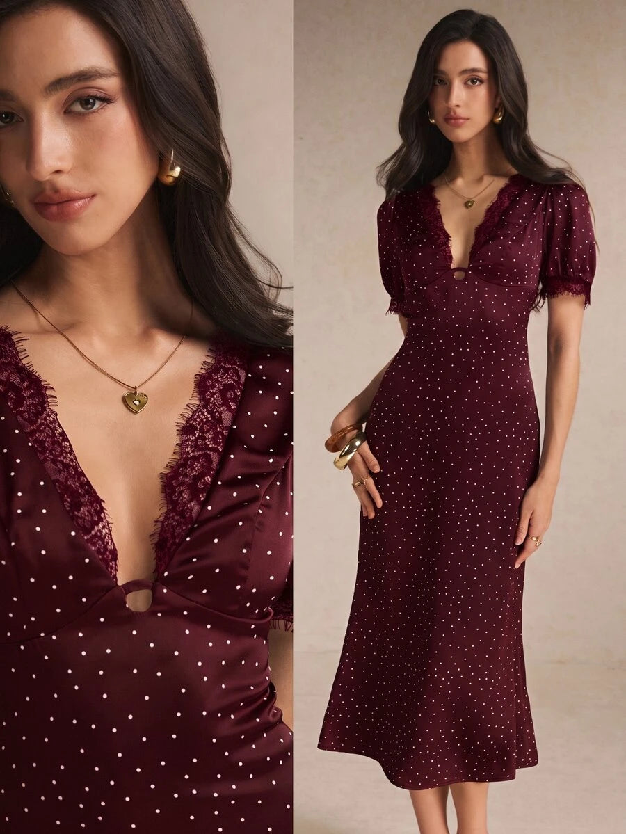 Burgundy polka-dot midi dress close-up showing lace neckline and center cutout