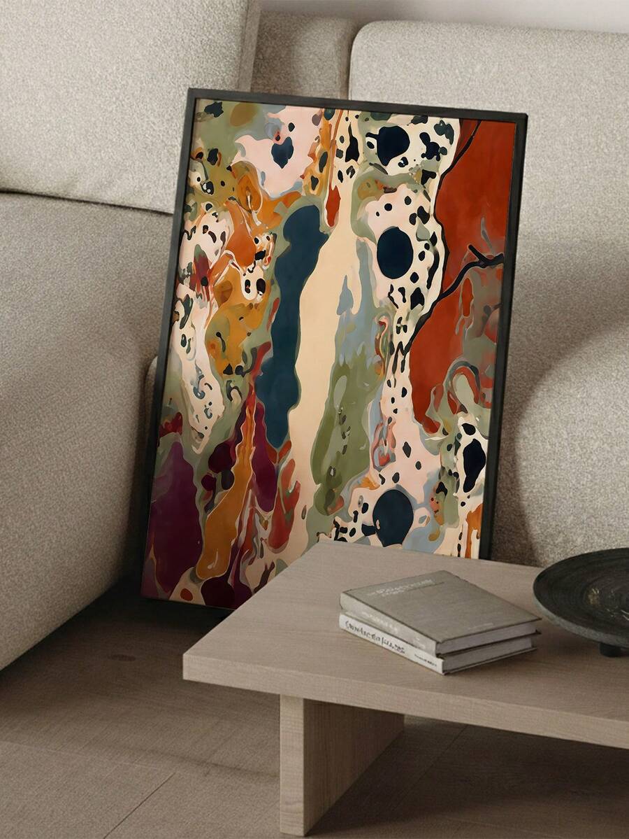 Living room view of framed abstract canvas art in rust, sage, cream and deep teal above a white sofa