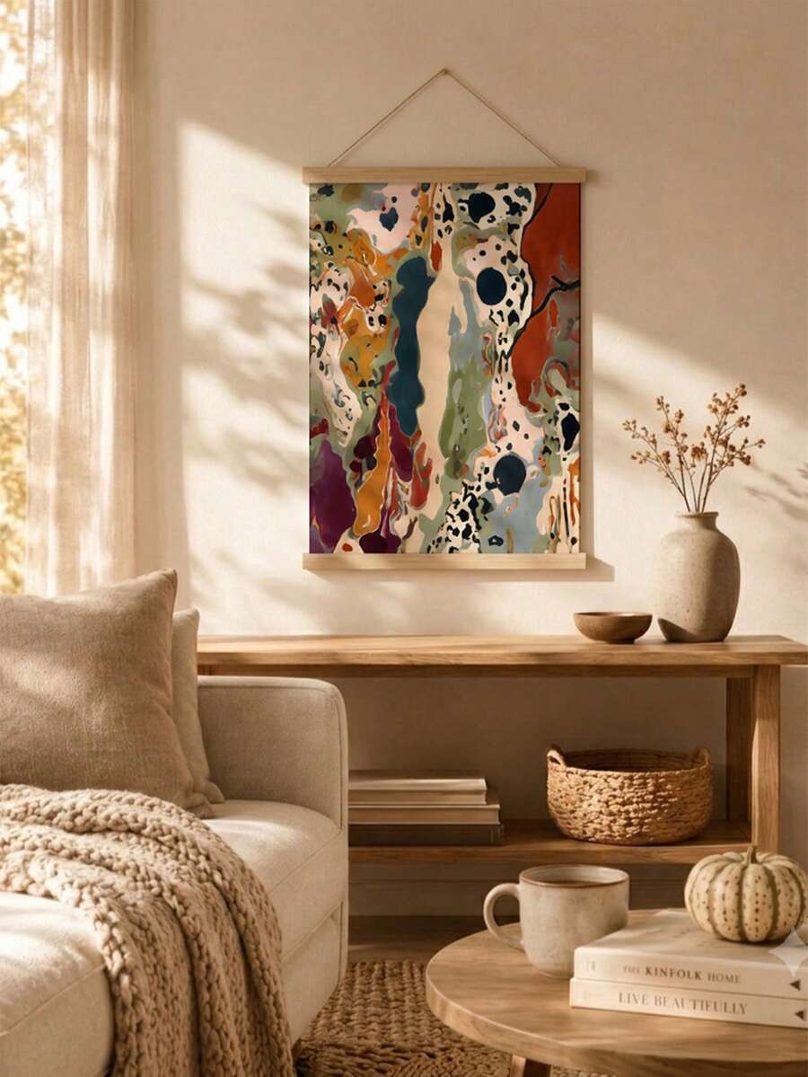 Front view of earthy abstract wall art suspended between wooden hanger rails above a console in a sunlit room