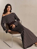 Seated view of brown striped cropped top and coordinated long skirt set