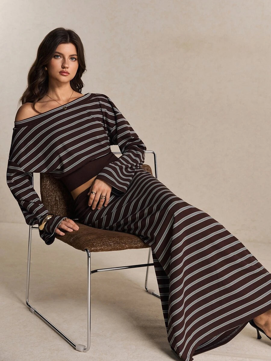 Seated view of brown striped cropped top and coordinated long skirt set