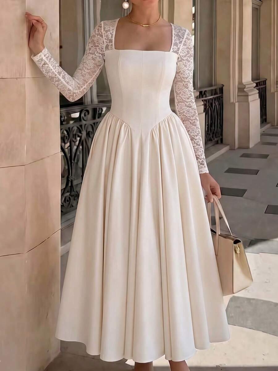 Three-quarter front view of an ivory dress with a square neckline, fitted bodice, floral lace sleeves and gathered full skirt.