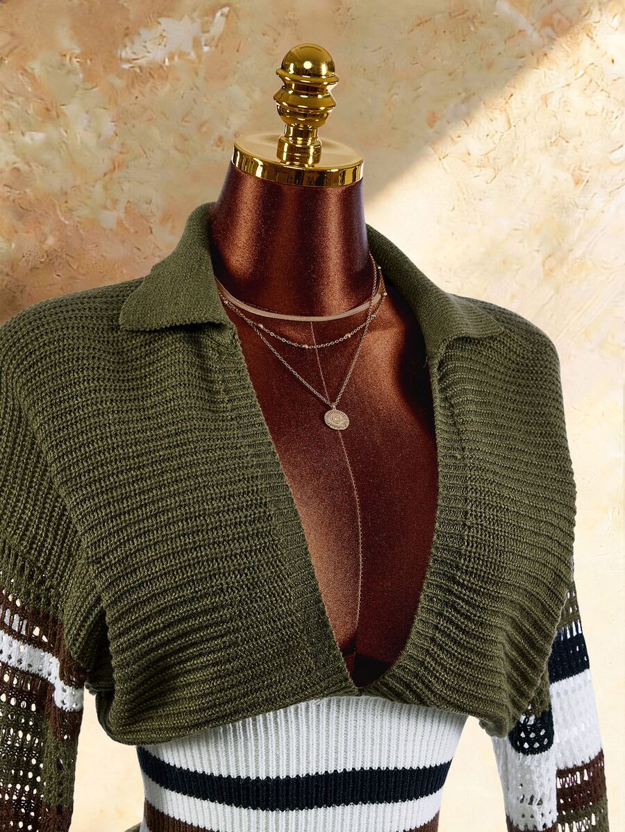 Close view of olive wide collar knit crop top with open front and striped sleeves