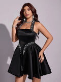 Open-back black halter dress with adjustable bow tie detail
