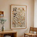 Straight-on room view of dried wildflower canvas art in a gold frame with white mat