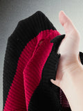 Close view of red and black rib-knit texture with distressed frayed edge finish