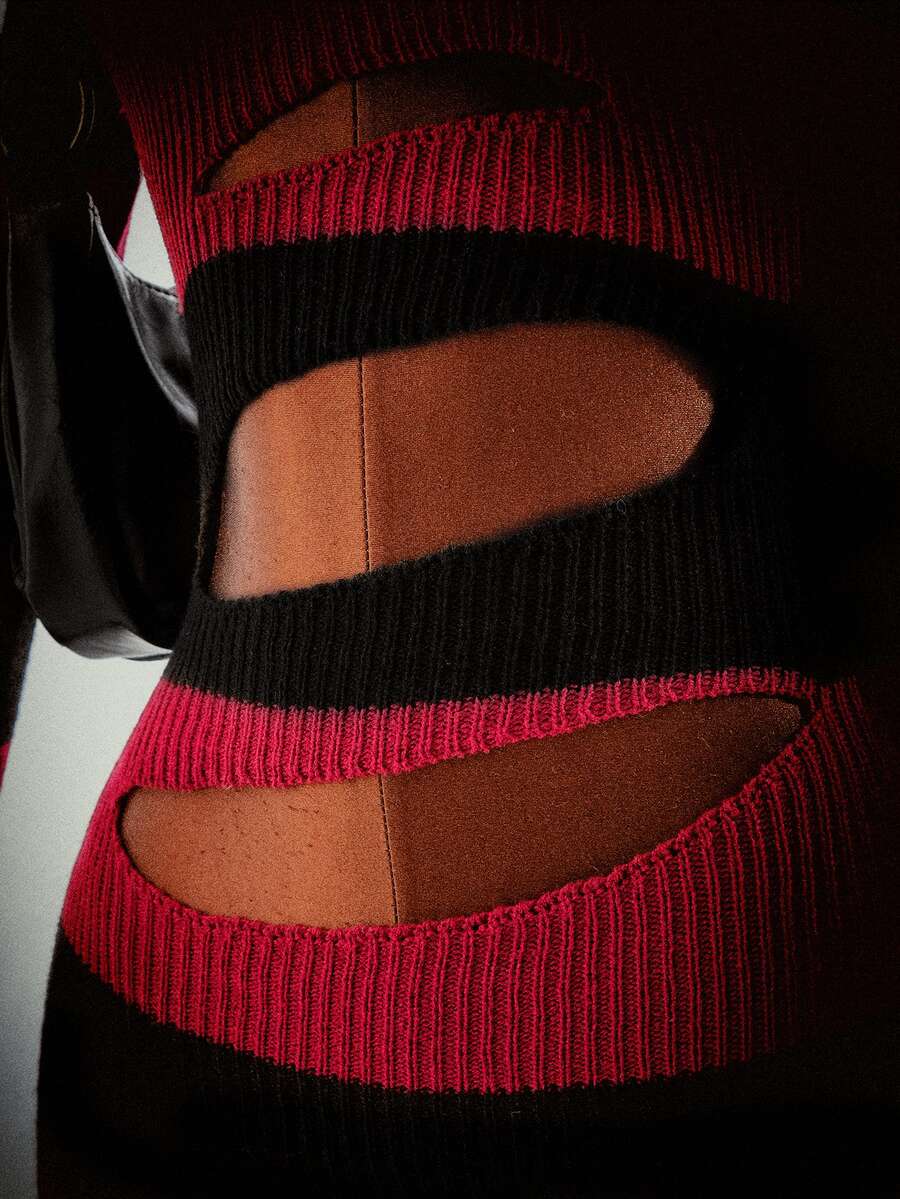 Close view of striped rib-knit waist and skirt cutout details on gothic mini dress