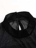 Detail view of black velvet-look high collar with transparent mesh neckline construction