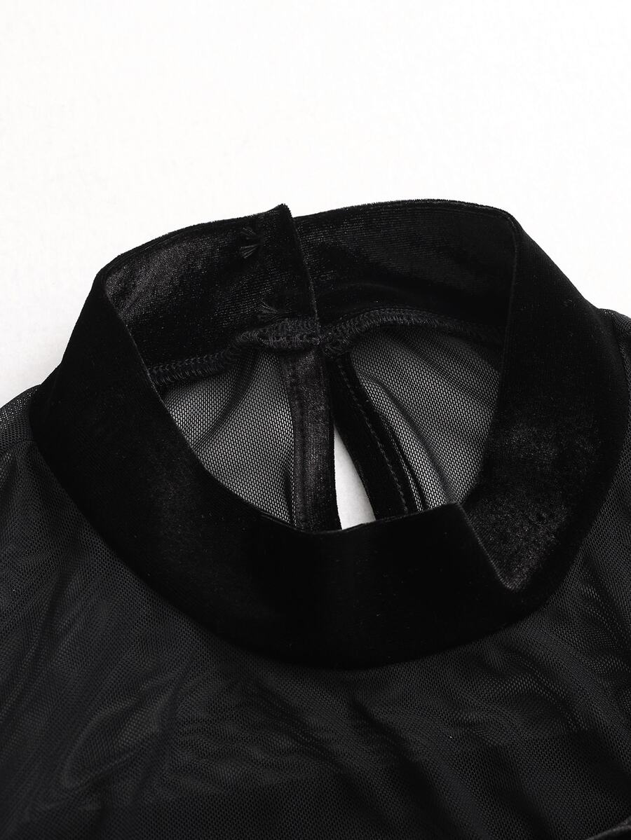 Detail view of black velvet-look high collar with transparent mesh neckline construction